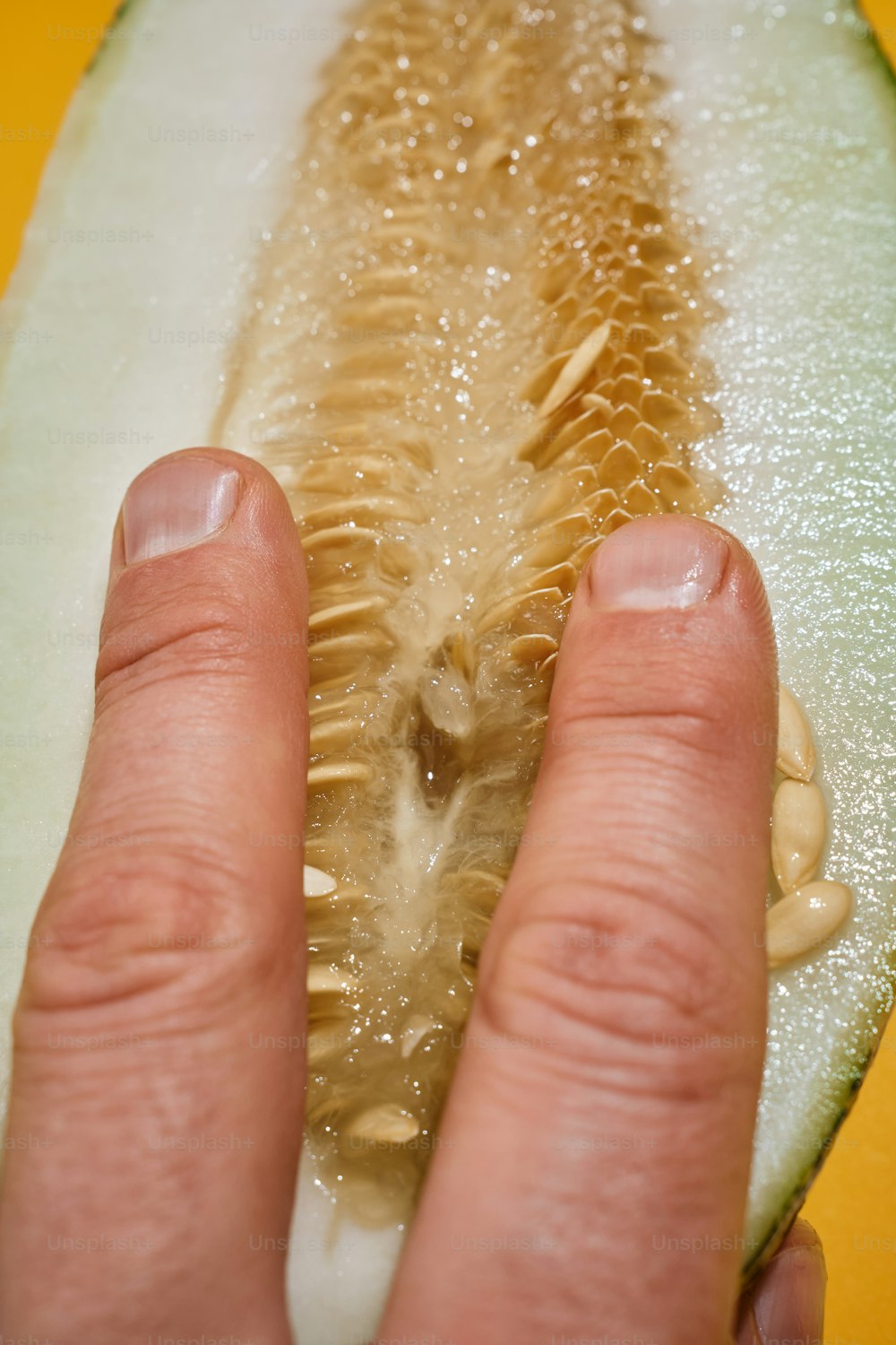 a close up of a person holding a piece of fruit