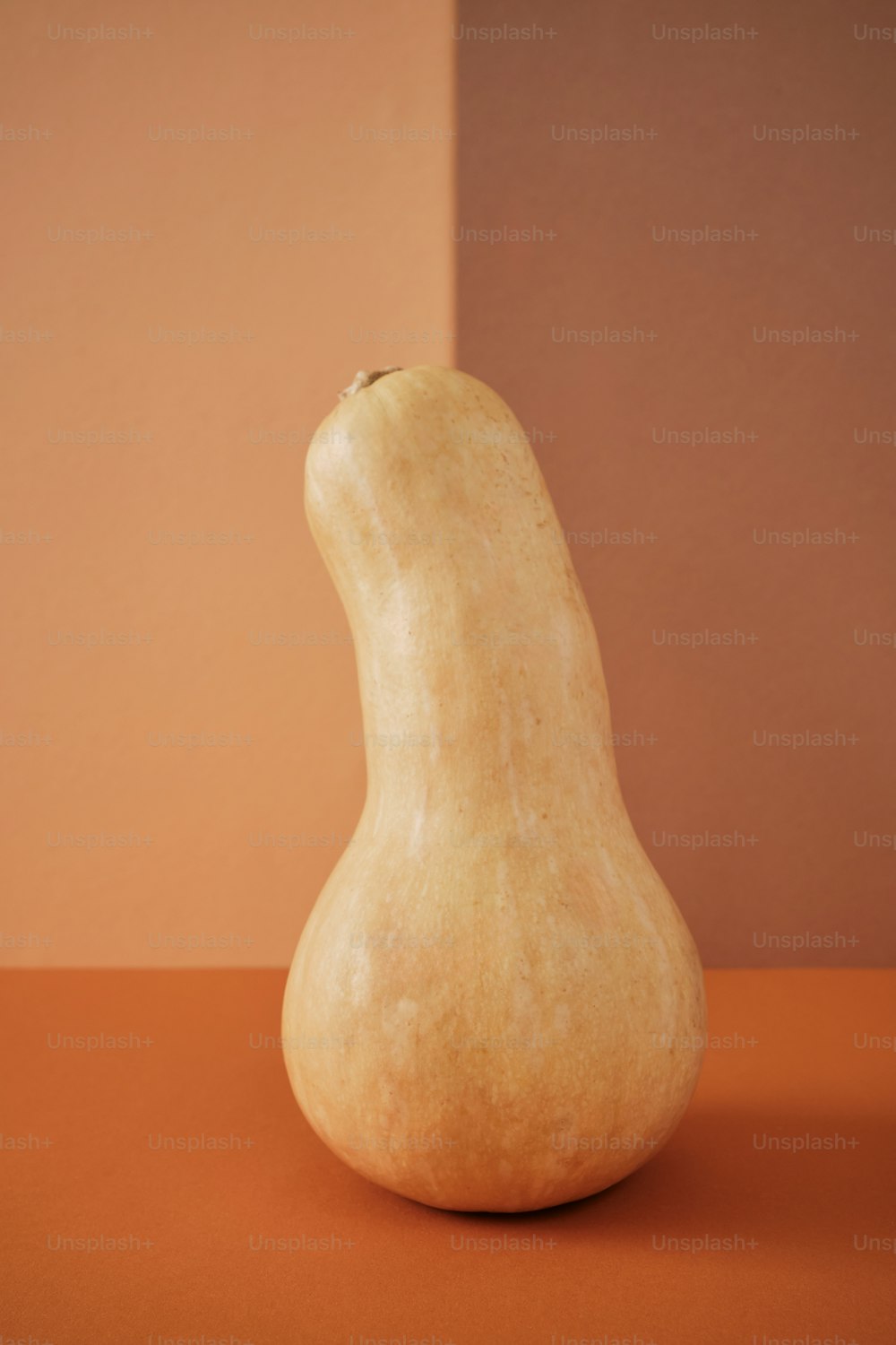 a pear sitting on top of a table next to a wall