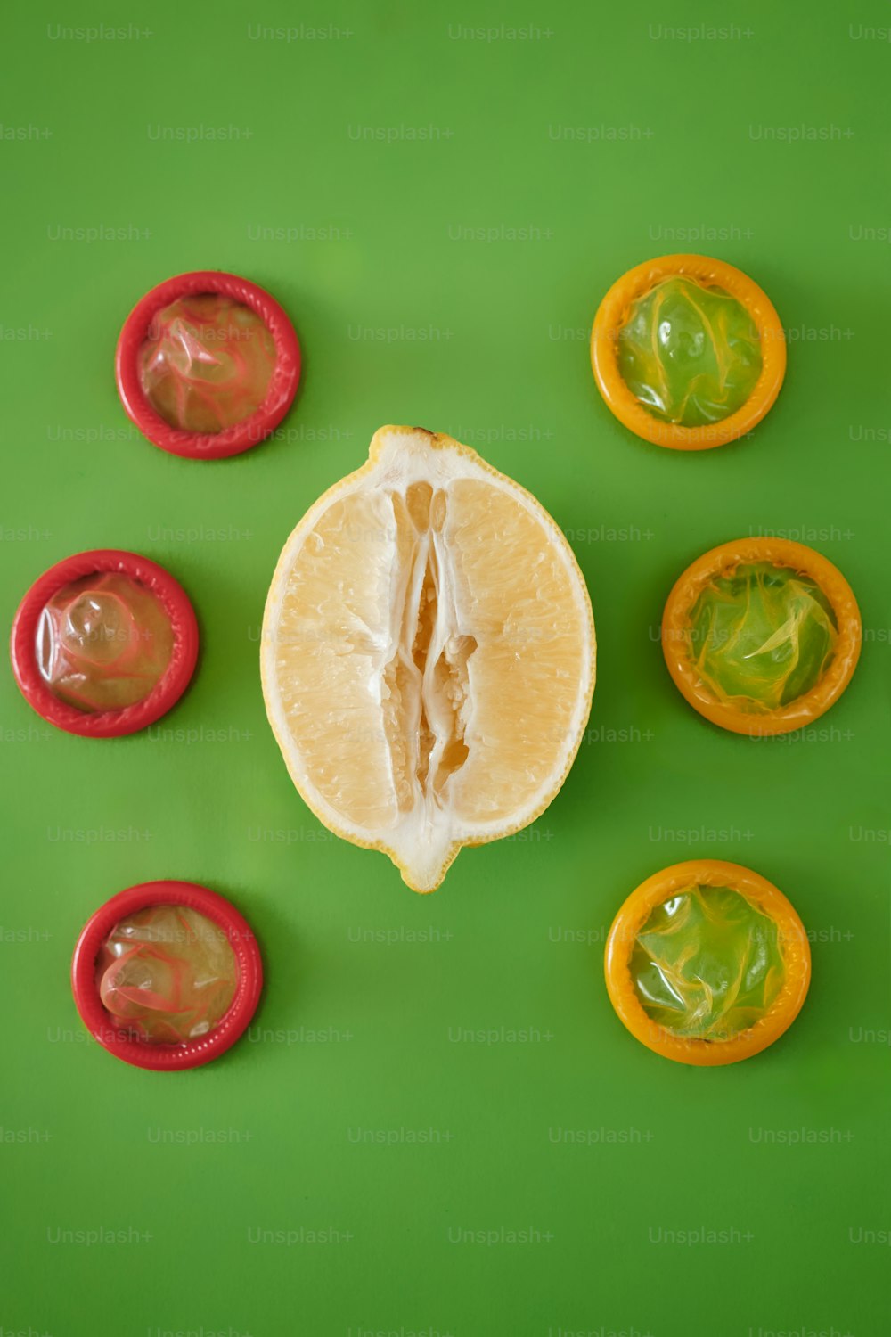 a sliced orange sitting on top of a green table