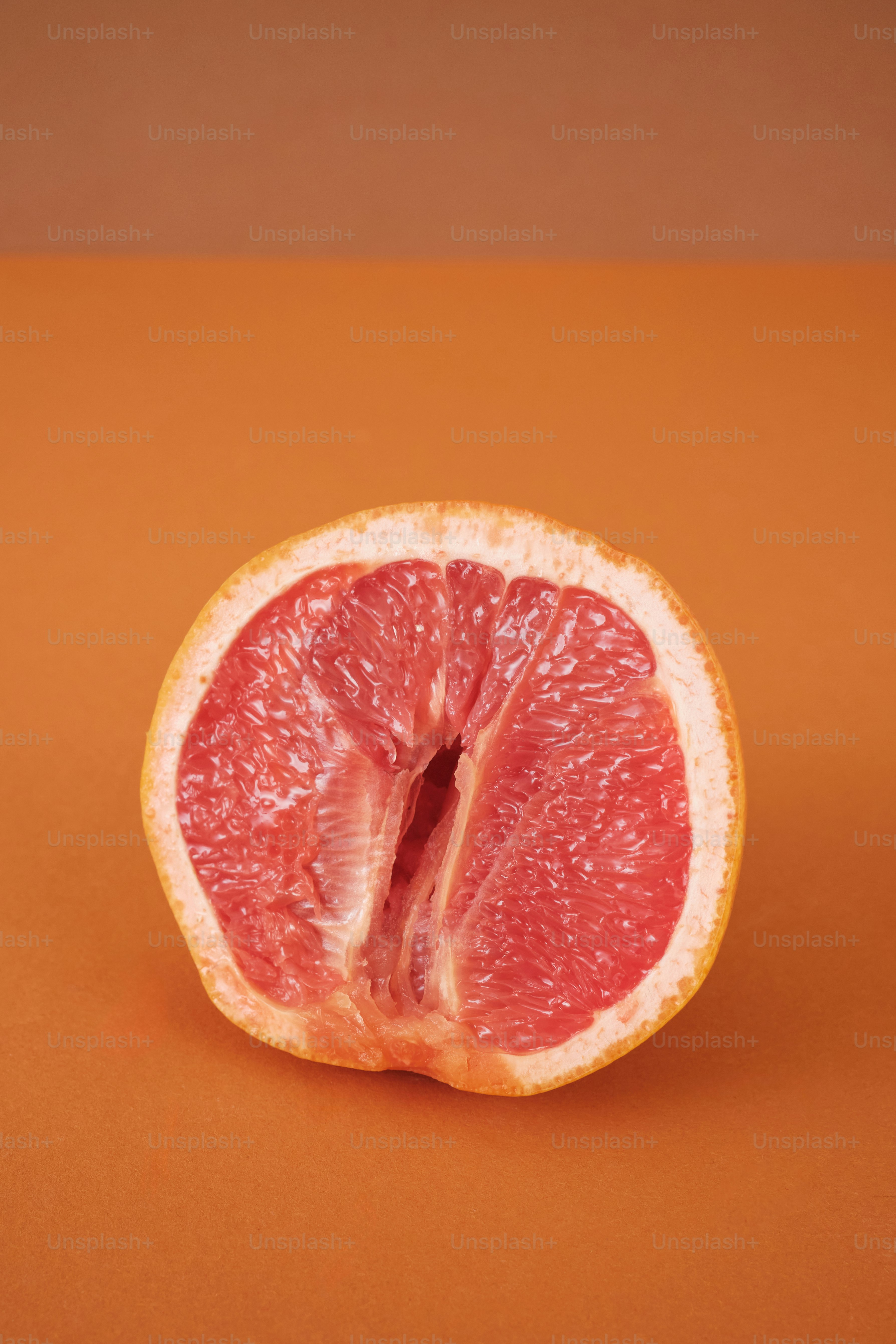 a cut of a citrus fruit resembling a woman's vulva