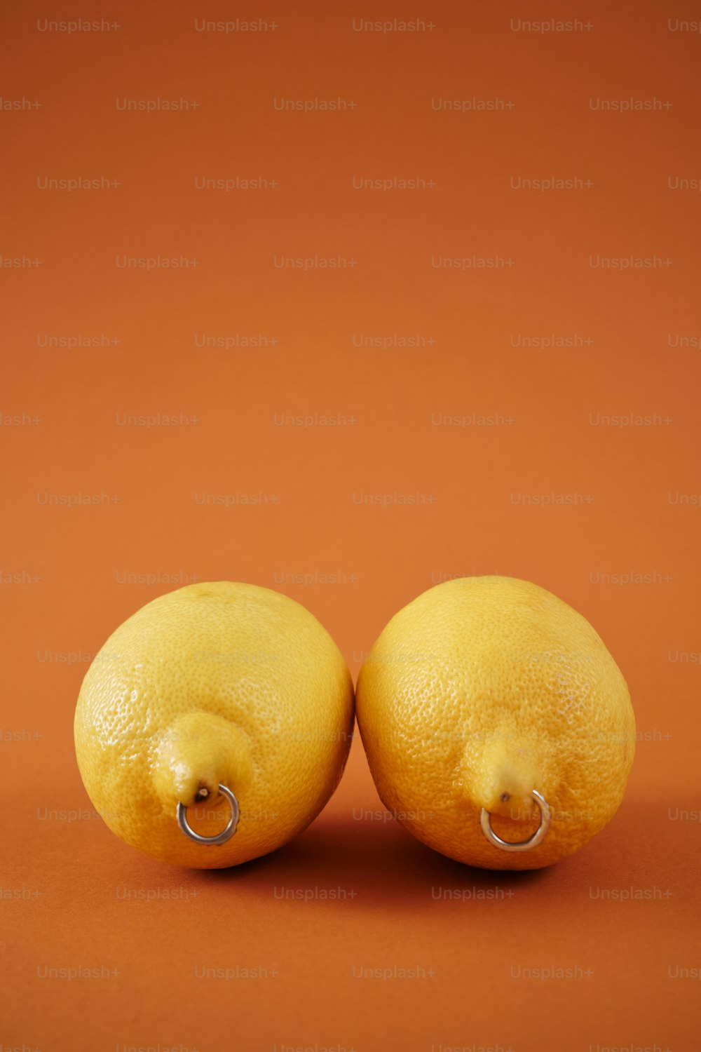 two lemons sitting next to each other on a table
