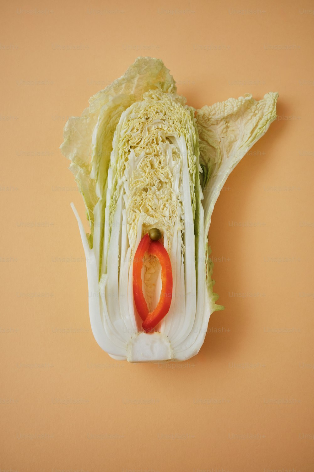 a head of cabbage with a red pepper in it