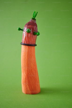 a carrot with a green stem sticking out of it