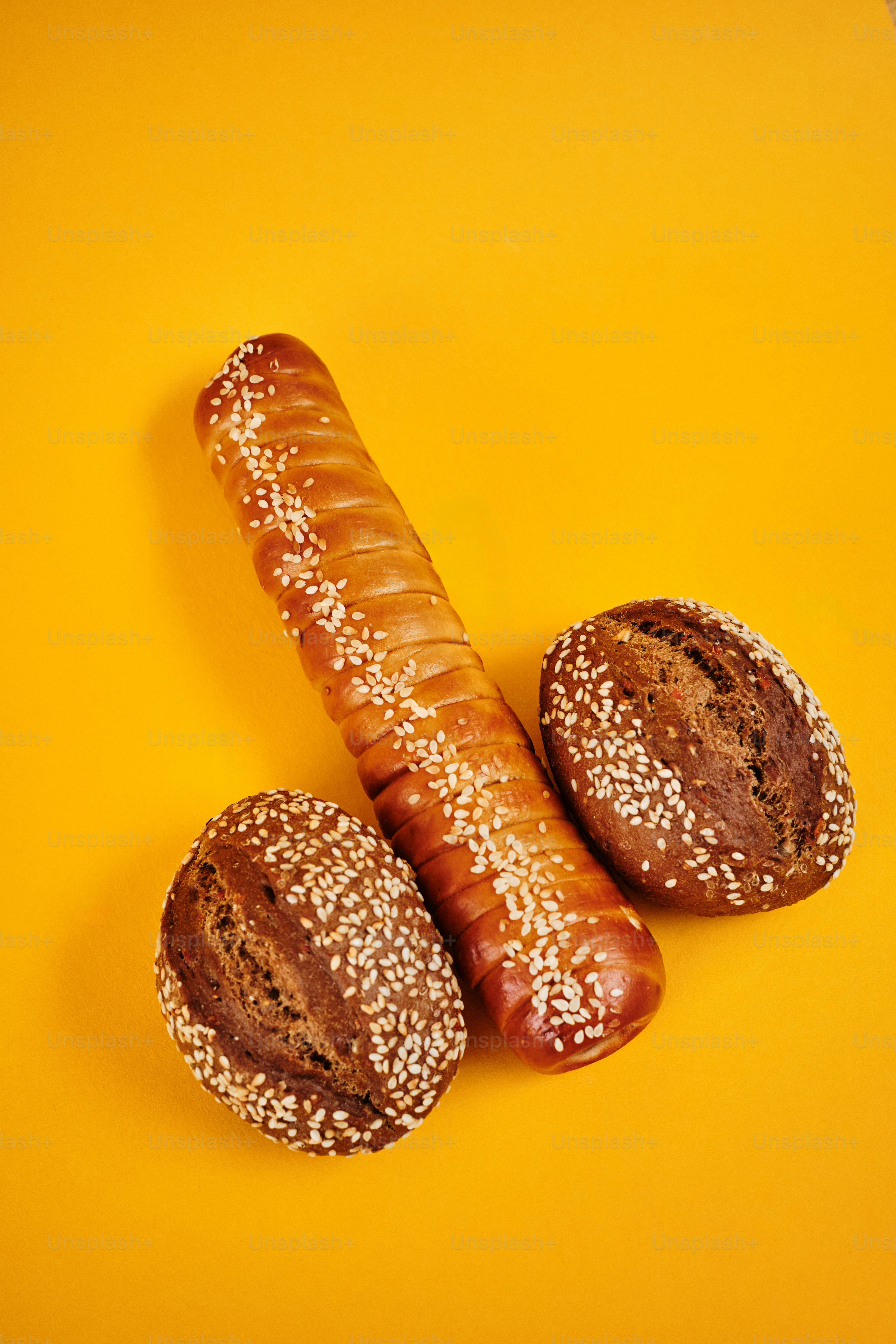 a couple of breads sitting on top of a yellow table