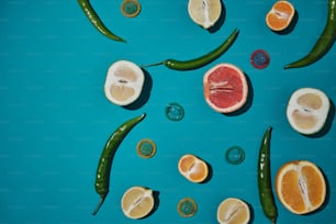 a group of fruits and vegetables on a blue surface