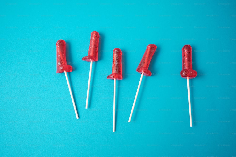 a group of red lollipops sitting on top of each other