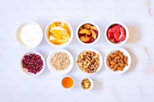 a table topped with bowls of fruit and nuts