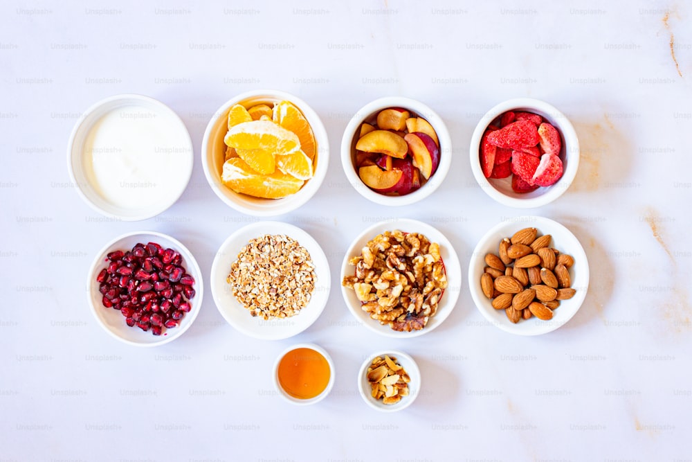 a table topped with bowls of fruit and nuts