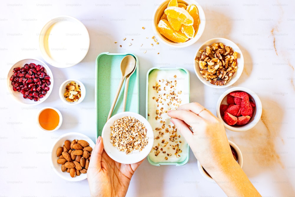 a person holding a spoon over a bowl of cereal