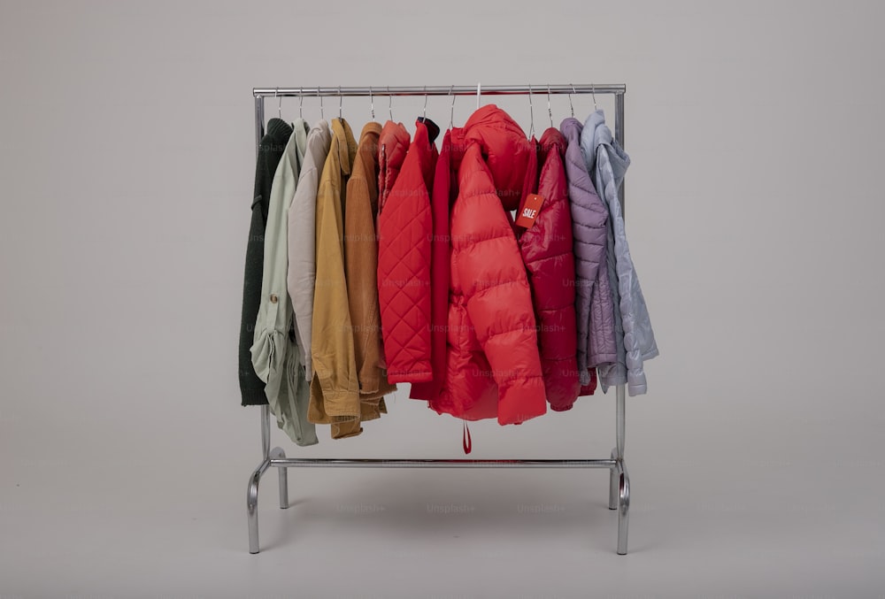 a rack of coats hanging on a clothes rack