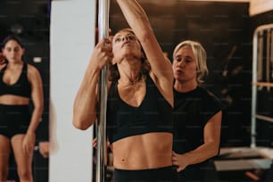 a woman in a black sports bra top and a woman in a black sports bra