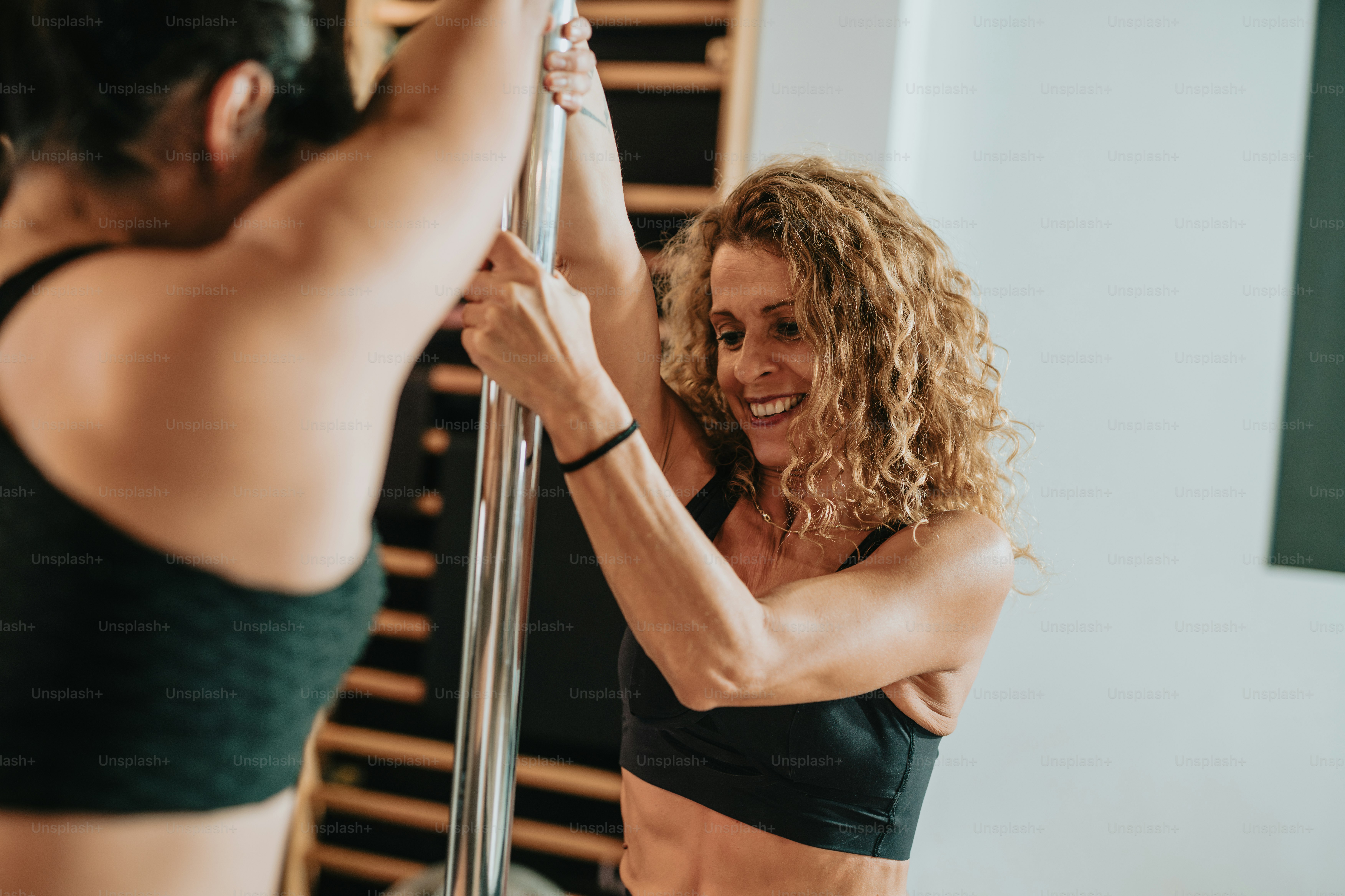 a woman in a black sports bra and a woman in a black sports bra and