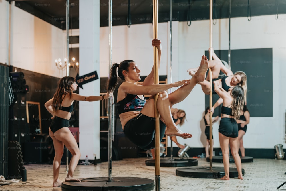 a group of women doing aerial acrobatics in a gym