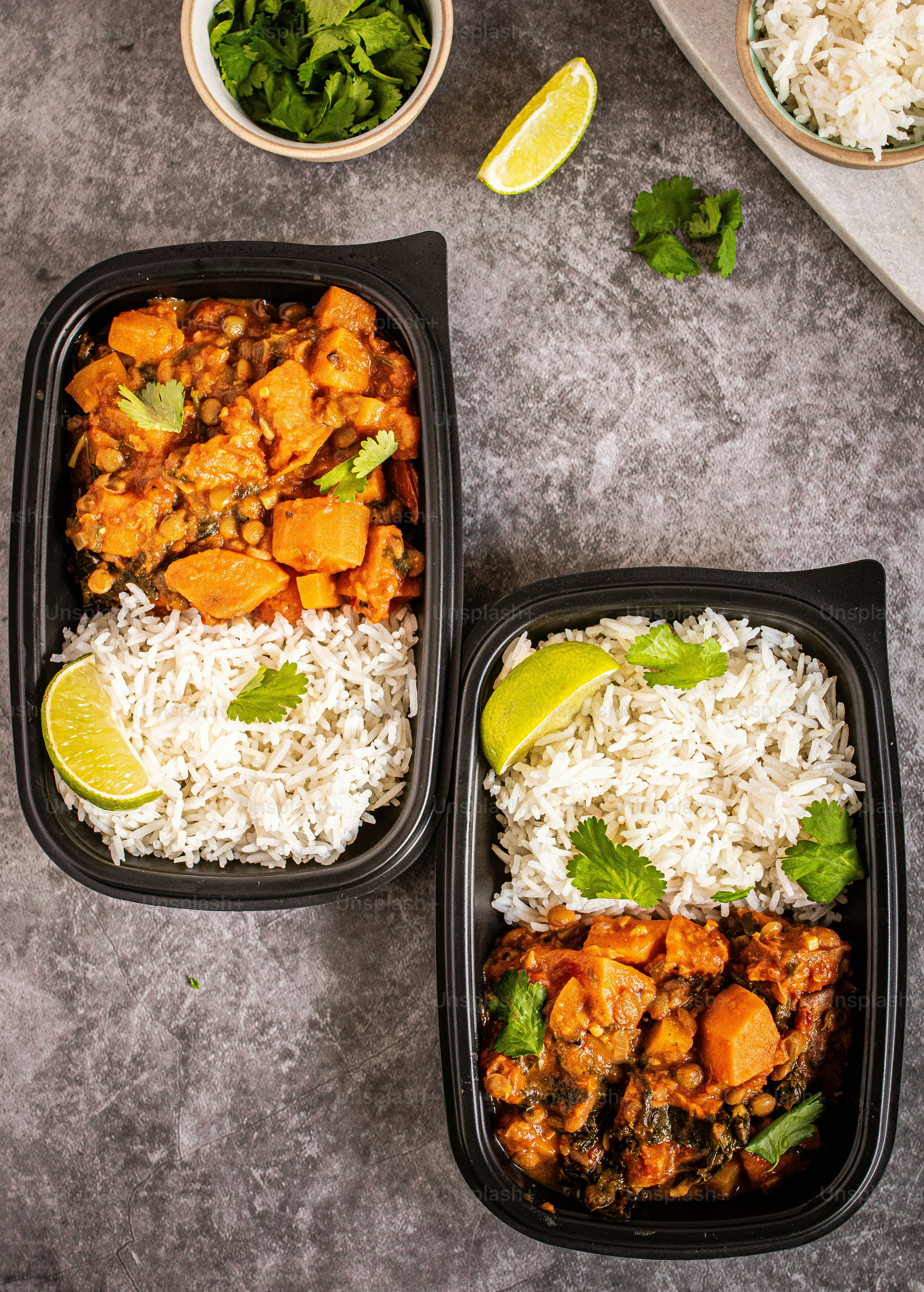 Two meal prep containers with food in them.