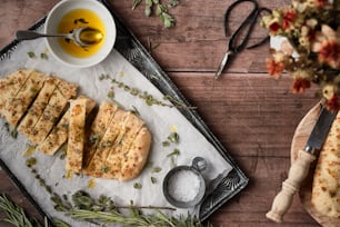 a table with a tray of food and a bowl of olive oil