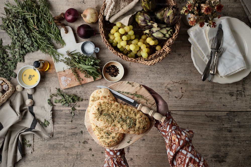 a person cutting a piece of food on a cutting board