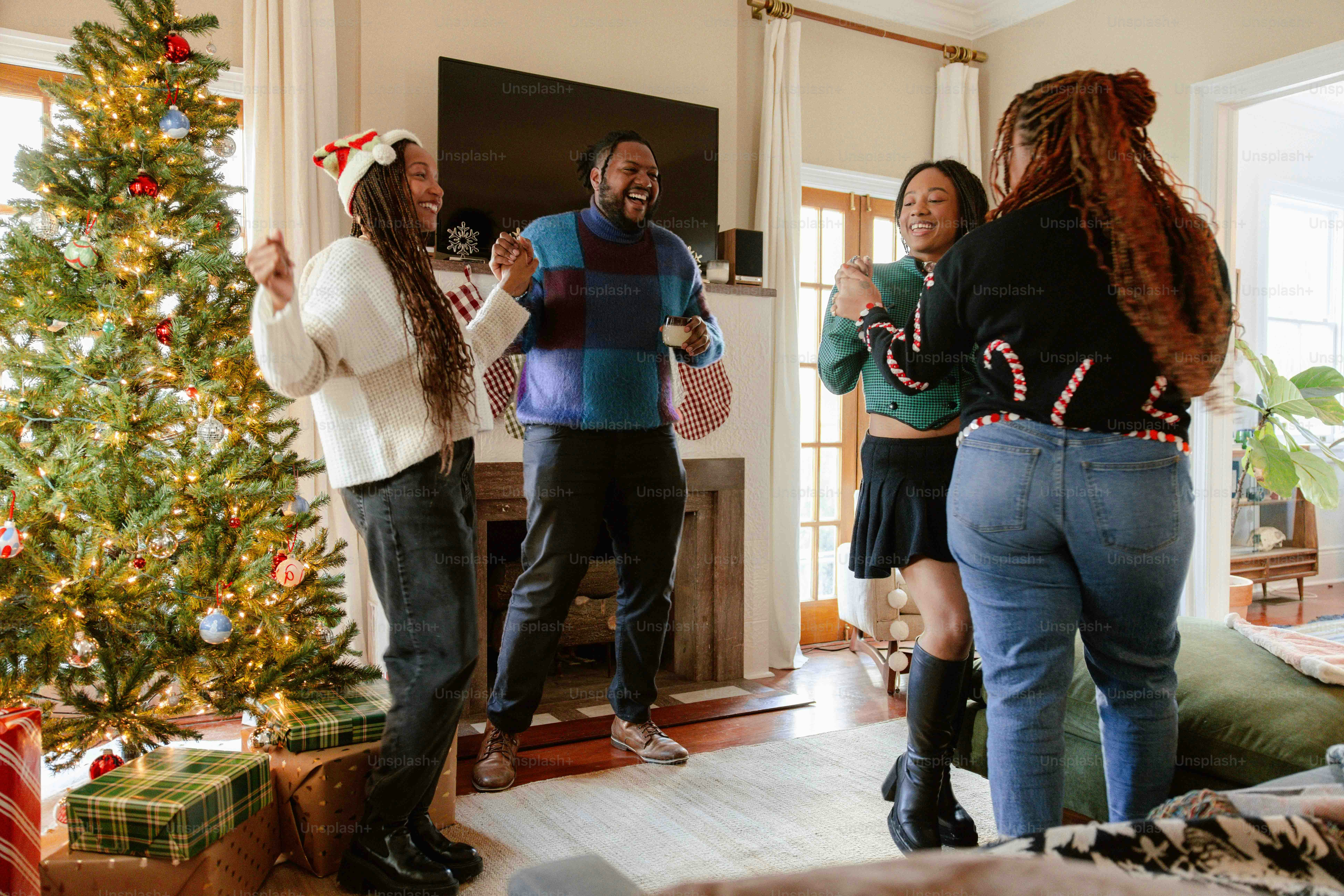 a group of people standing around a christmas tree