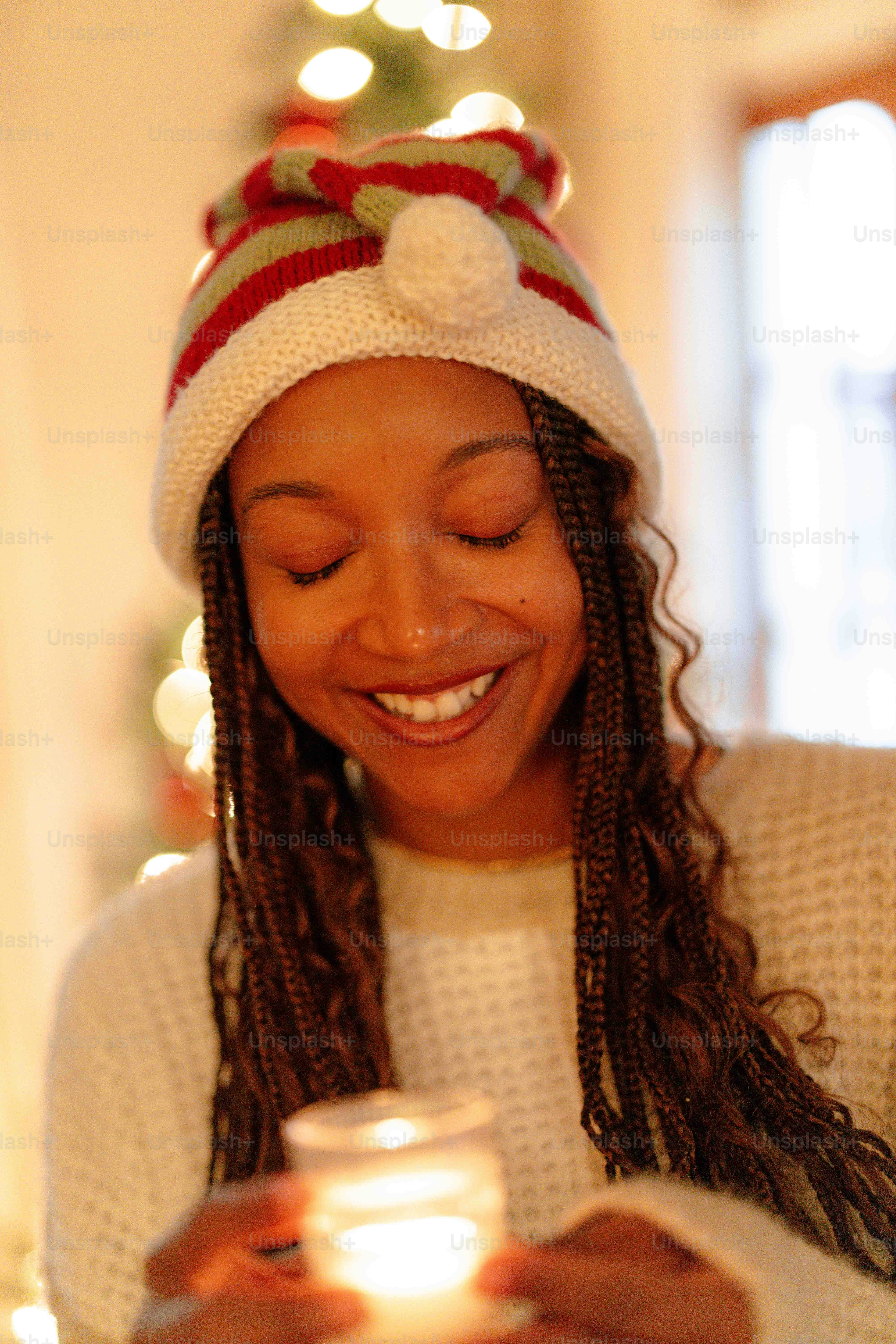 a woman smiles as she looks at her cell phone