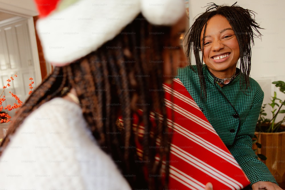 a woman with dreadlocks and a santa hat