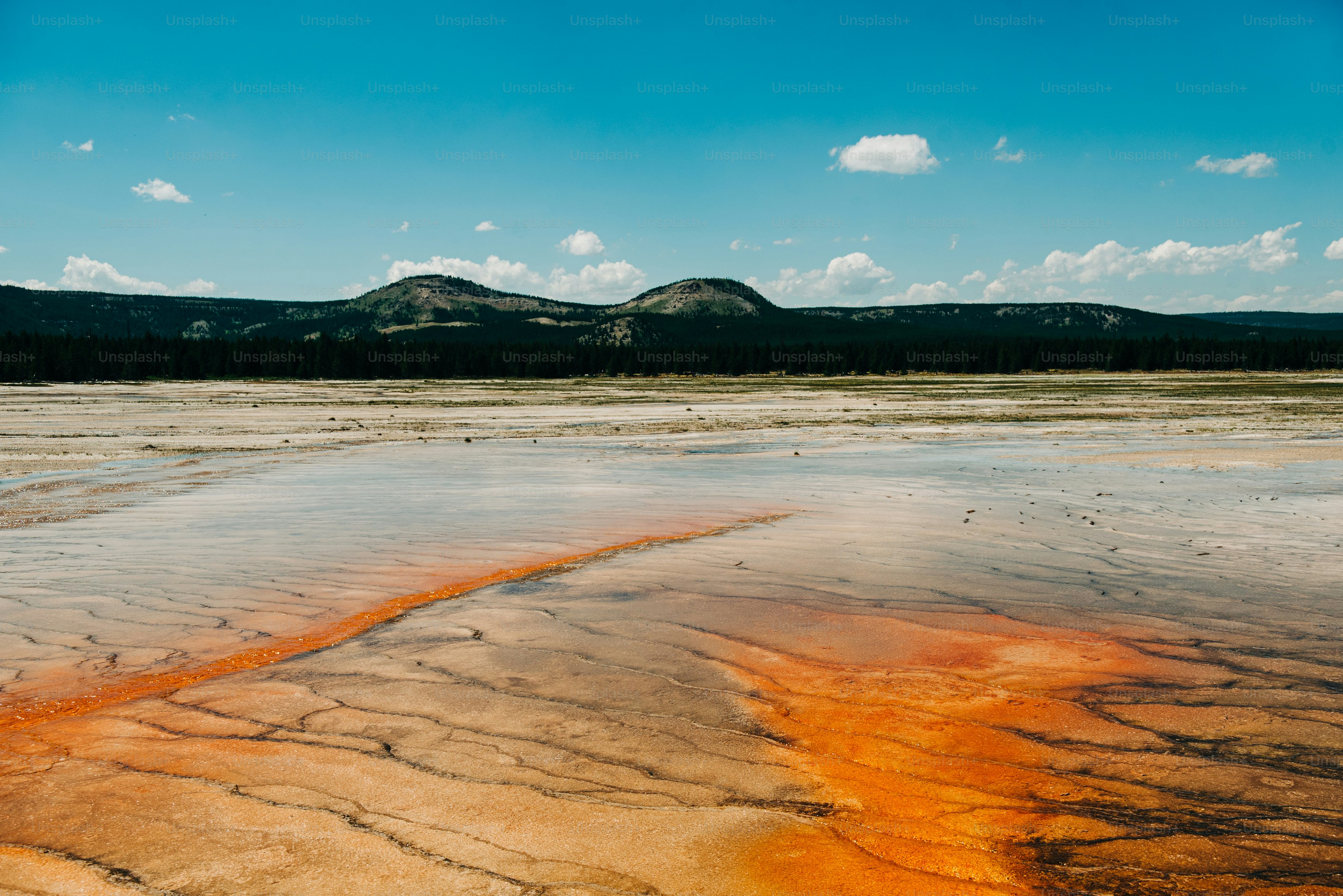 a large body of water with a mountain in the background