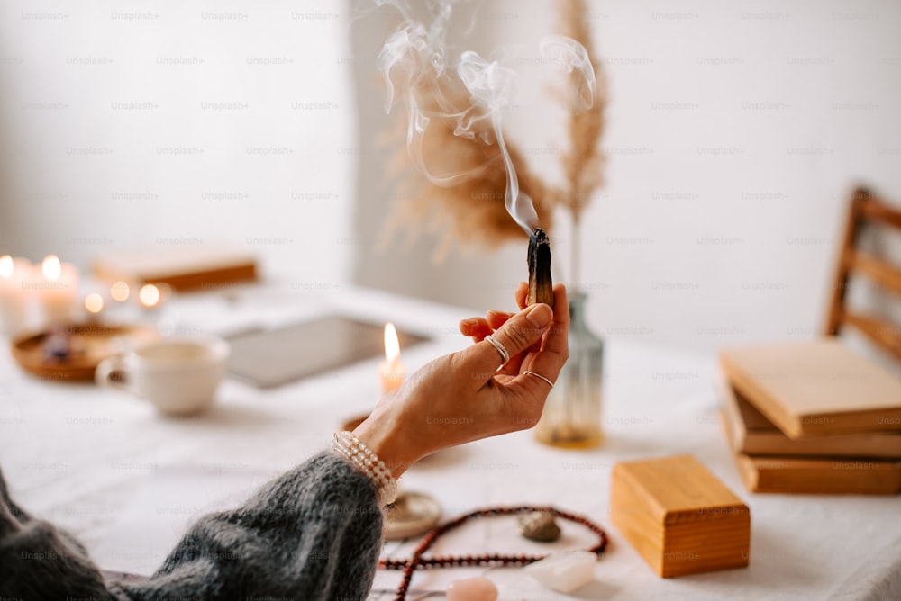 a woman holding a cigarette in her hand