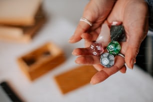 a person holding three dices in their hands