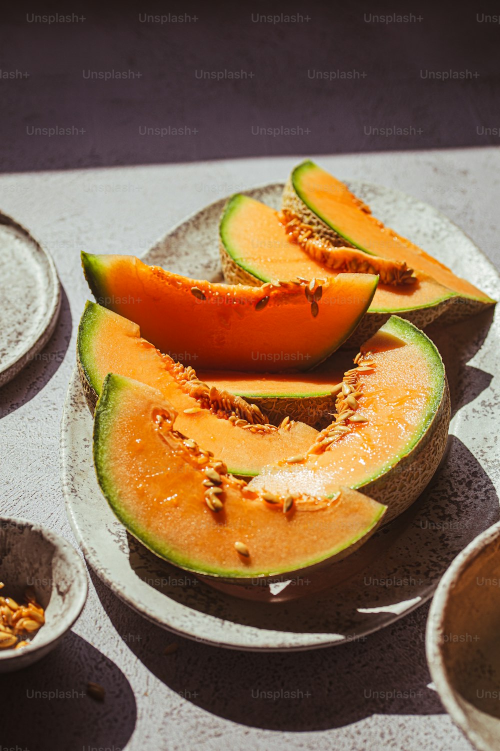 slices of melon on plates on a table