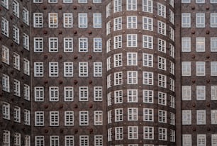 a tall building with many windows and a clock