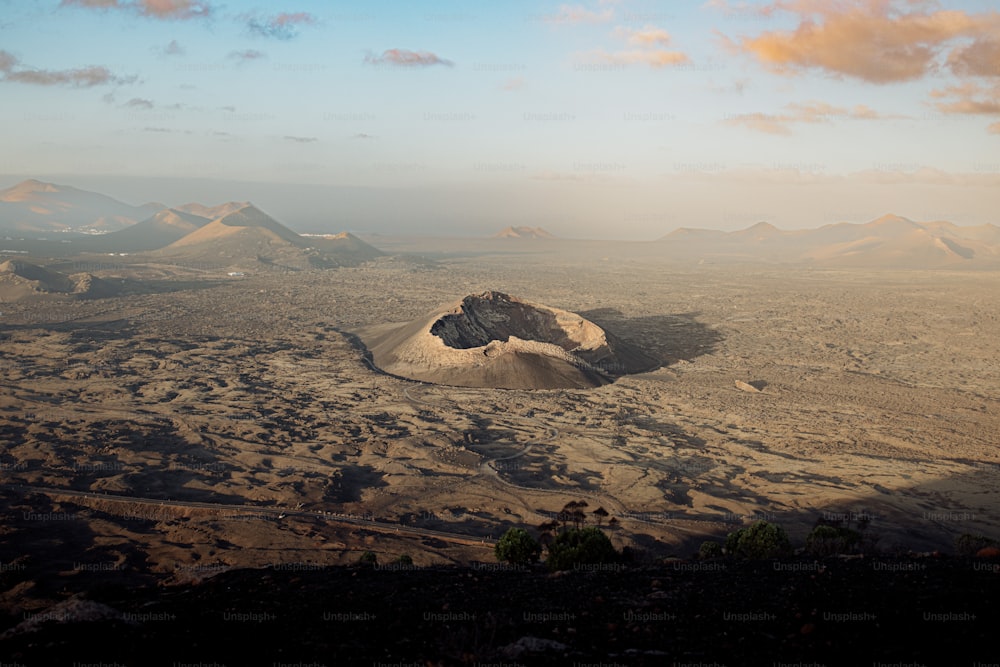 a barren landscape with mountains in the distance