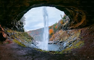 a view of a waterfall from inside a cave