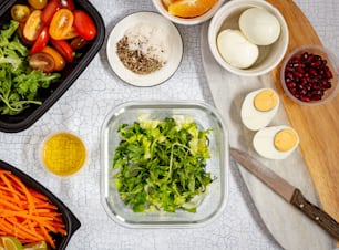 a table topped with bowls of food next to a cutting board