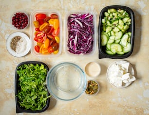 a table topped with plastic containers filled with food