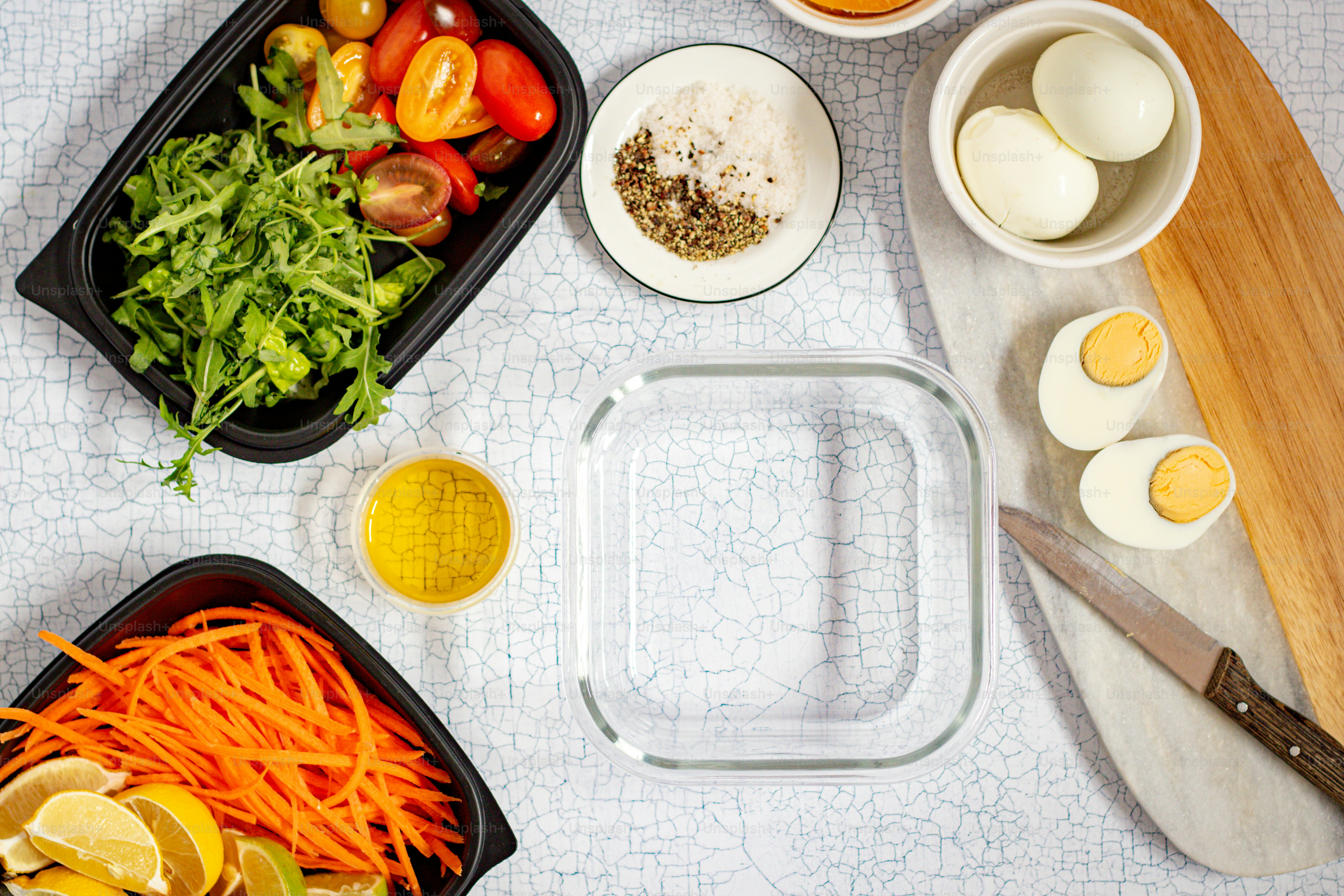 a table topped with bowls of food and a cutting board