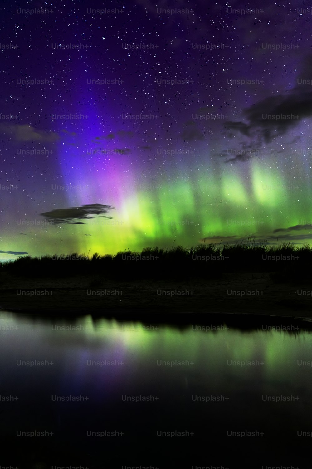 the aurora bore is reflected in the water