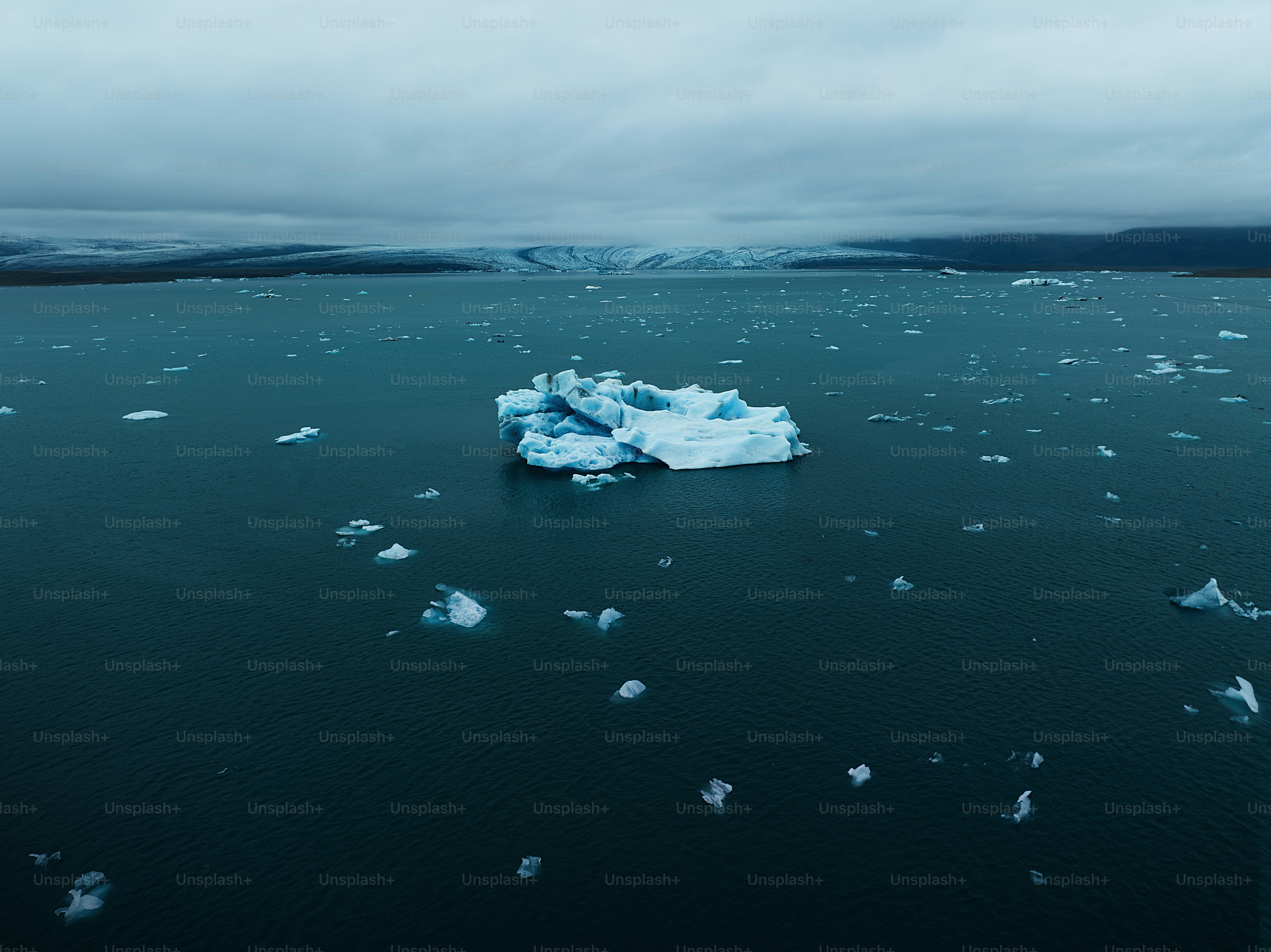 an iceberg floating in the middle of the ocean