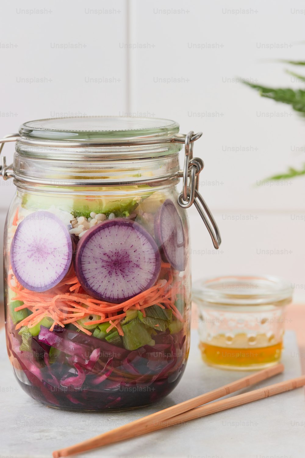 a mason jar filled with sliced up veggies