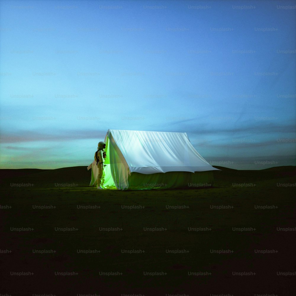 a white tent in a field with a sky background