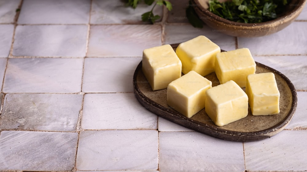a wooden plate topped with cubes of butter