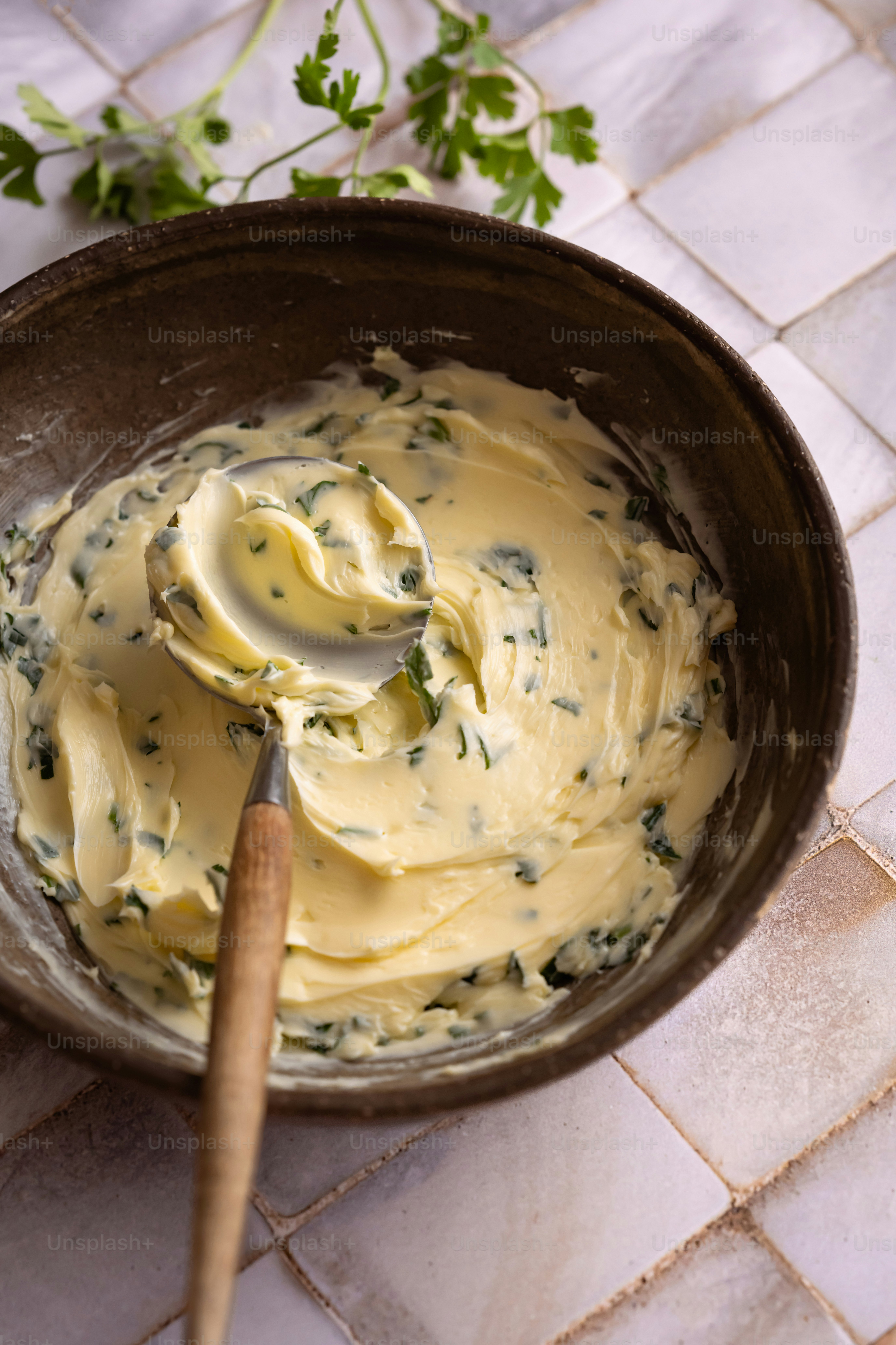 a wooden spoon in a bowl filled with cream