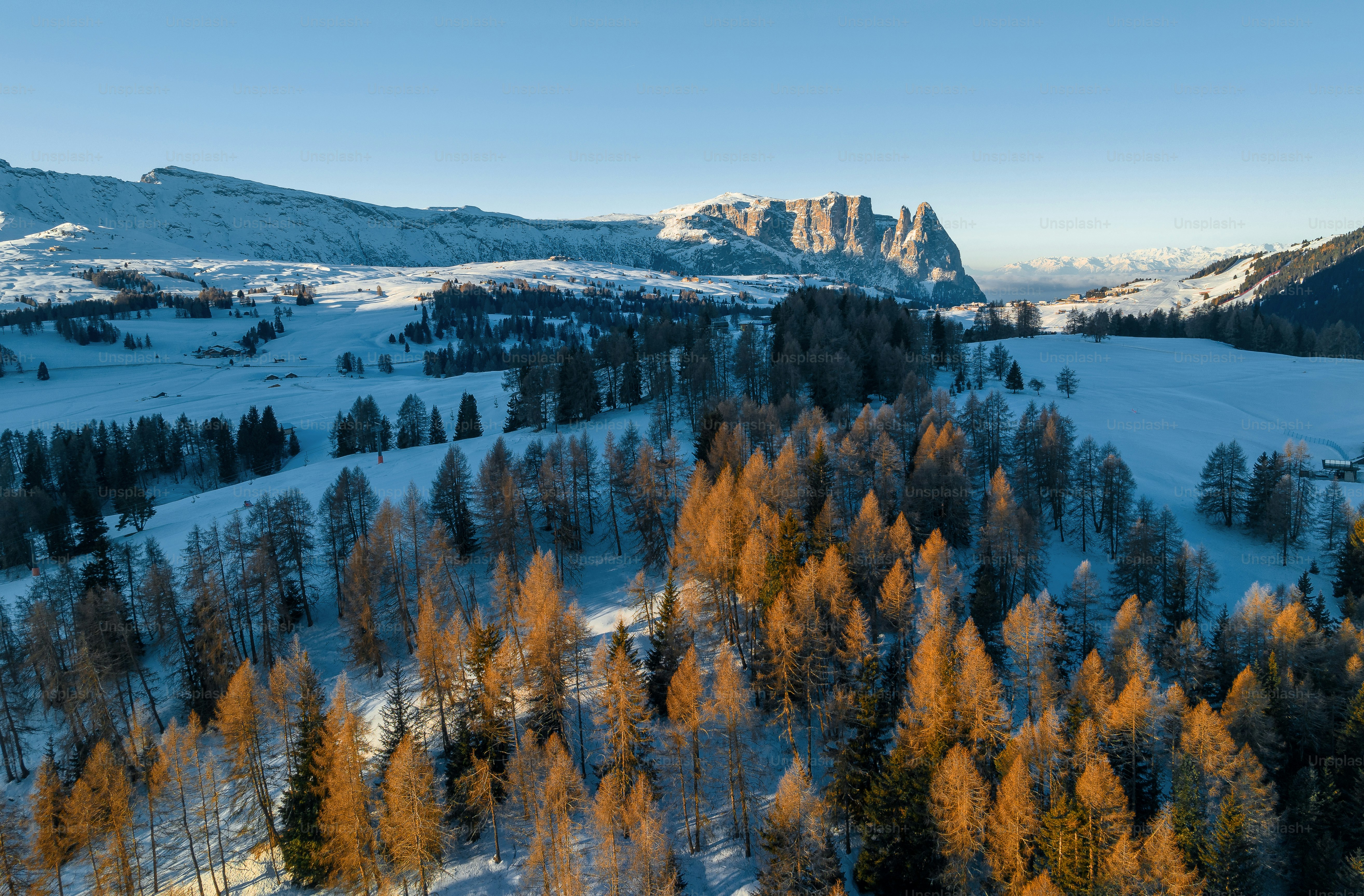 An aerial view of a snow covered mountain range photo – Travel Image on ...