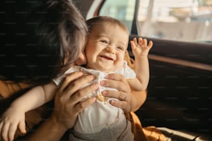 a woman holding a baby in her lap