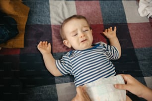 a baby laying on a bed with a diaper