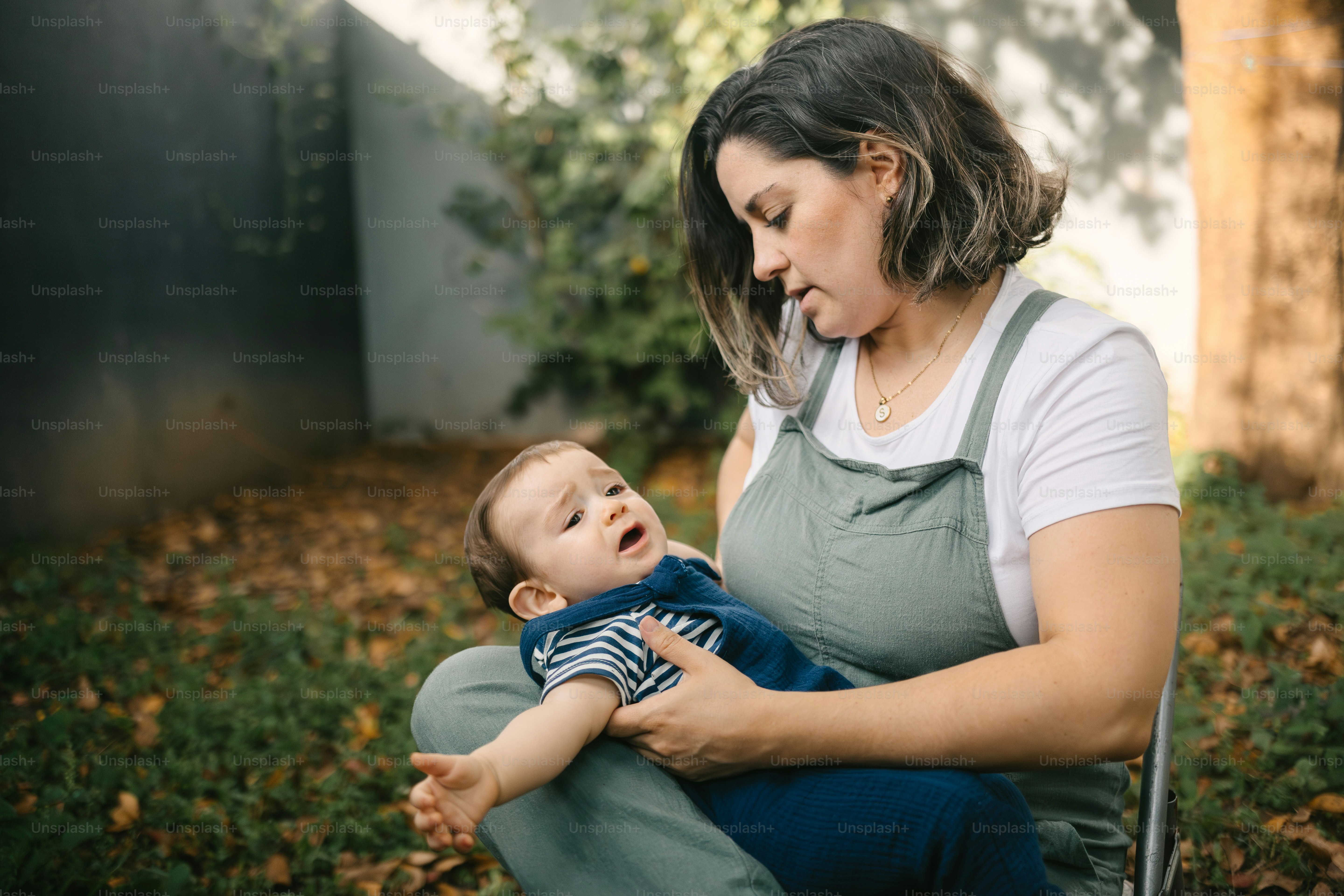 a woman holding a baby in her lap