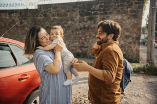 a man holding a baby and a woman holding a baby