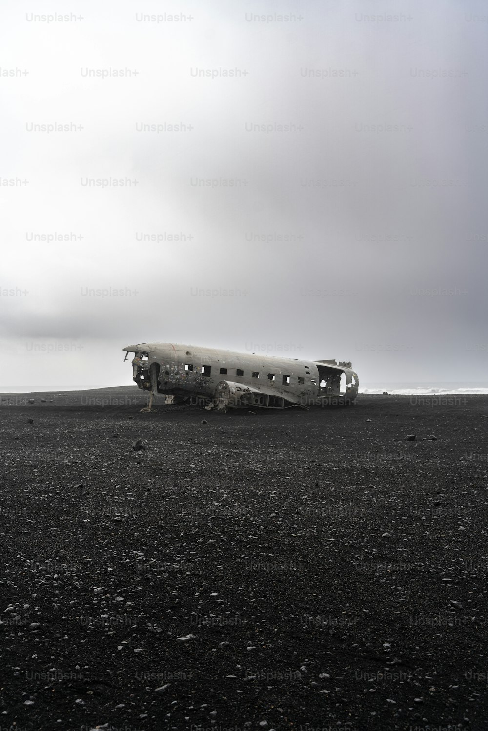 a plane sitting on top of a dirt field