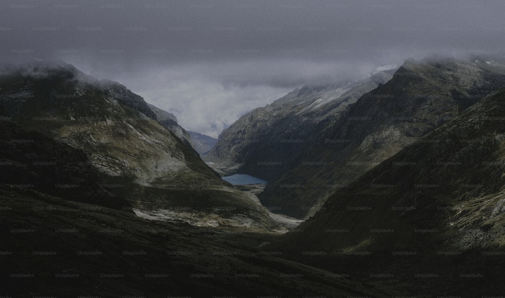 a view of a mountain range with a lake in the middle