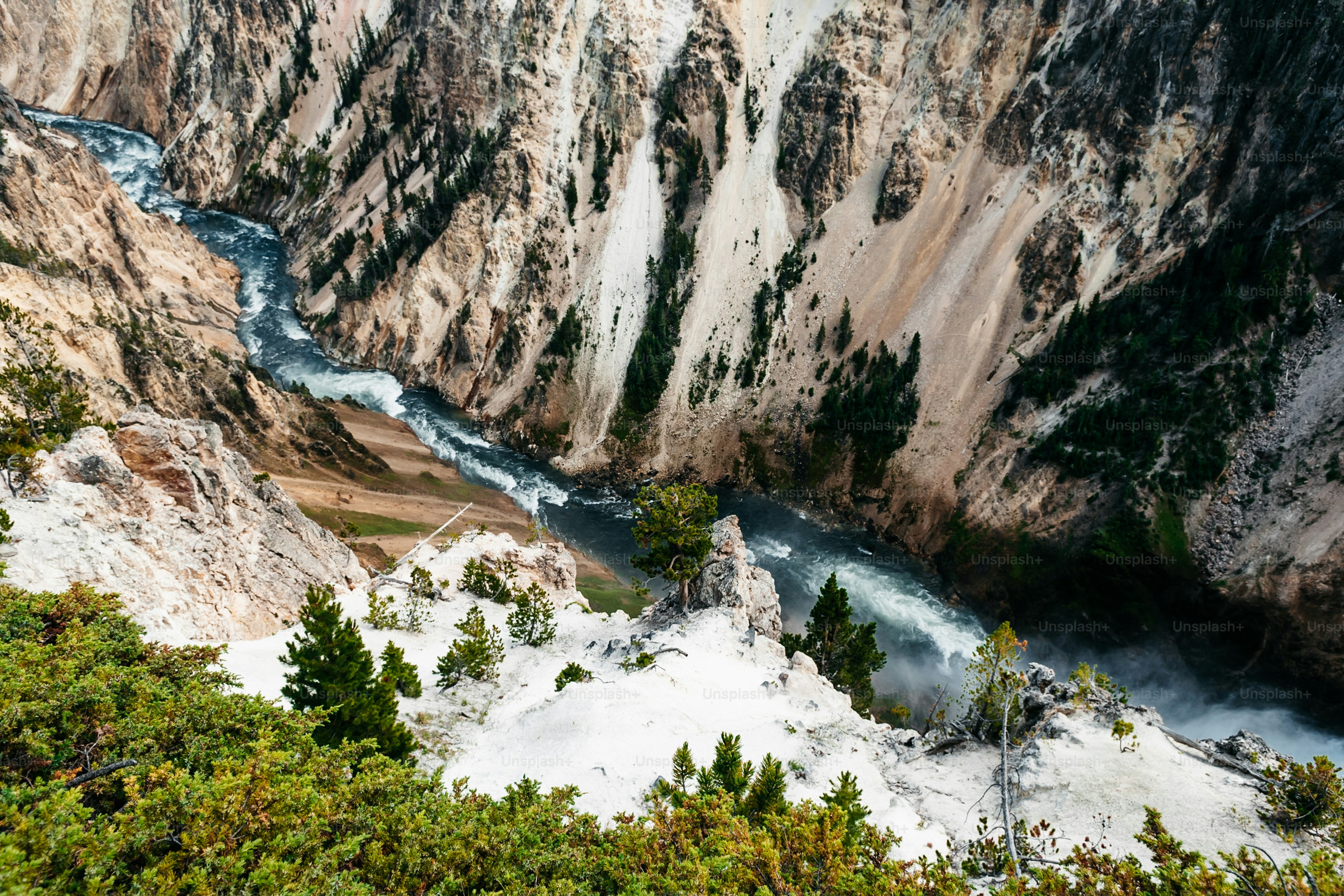 a river flowing through a canyon surrounded by mountains