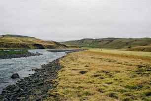 a river running through a lush green valley