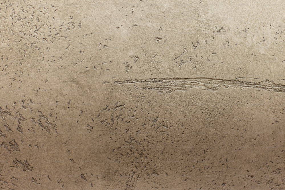 a person riding a surfboard on a sandy beach