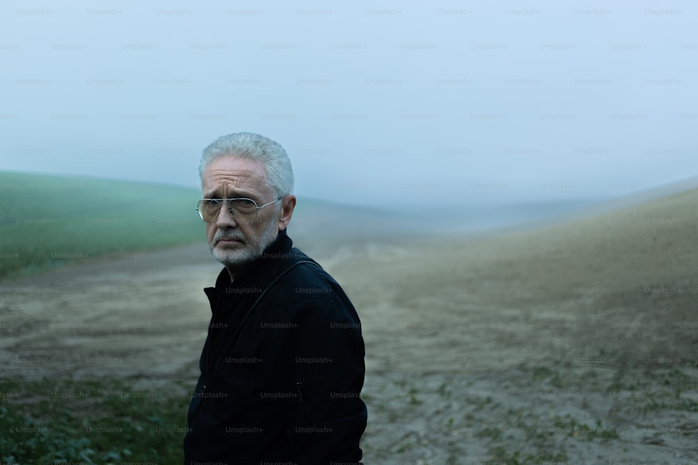 a man standing in the middle of a field